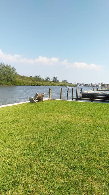This is the view from the back door. Fishing benches, bbq grill, outdoor table and boat slips are all just steps away!