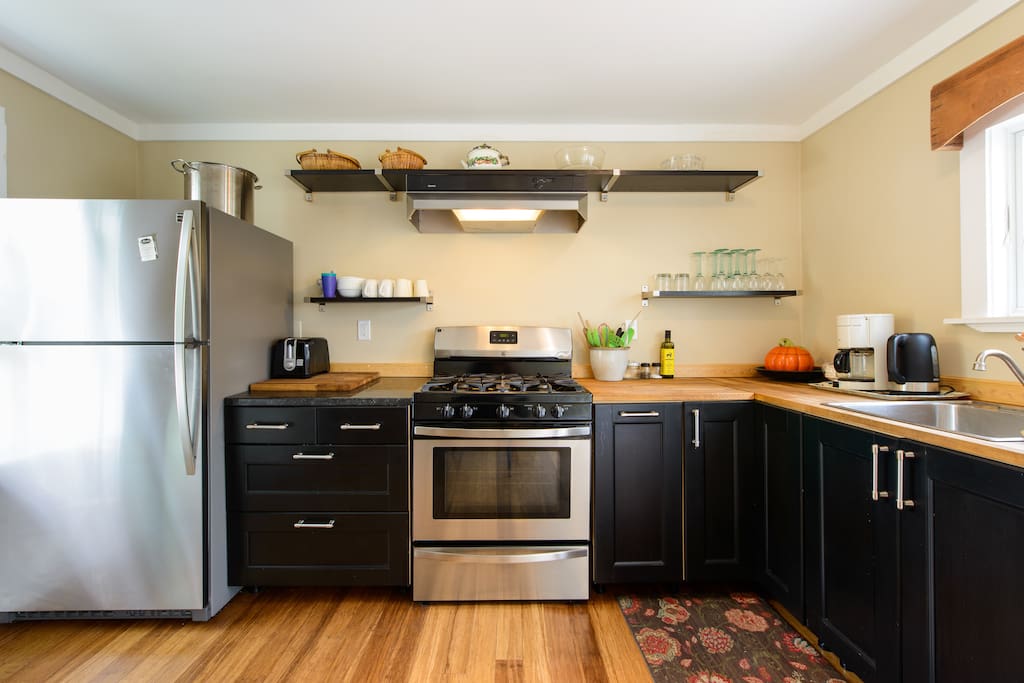 Fully-equipped kitchen with dishwasher, five-burner stove, and full-sized refrigerator