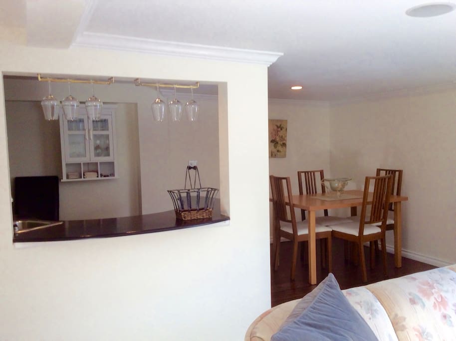 Wet Bar with fridge adjacent to dining table. Guests receive a "Taste of BC" from the host (BC wine and craft beer).