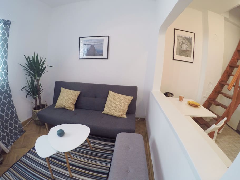 Living room and a glimpse at the dining area and loft stairs