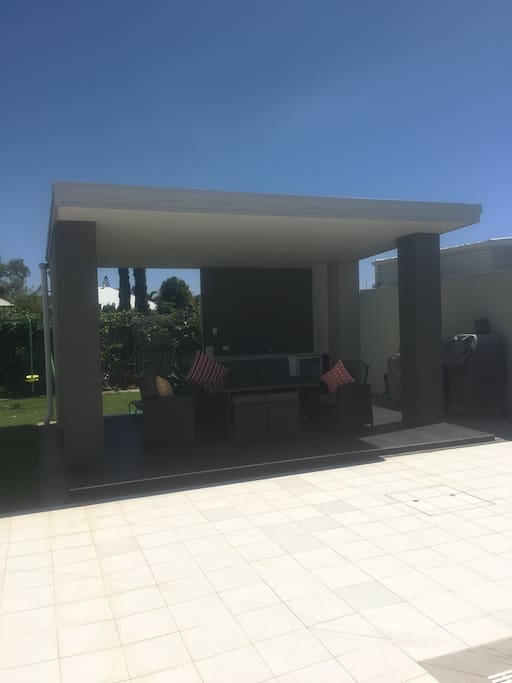 BBQ area, with fridge, sink, 4 burner BBQ and pizza oven