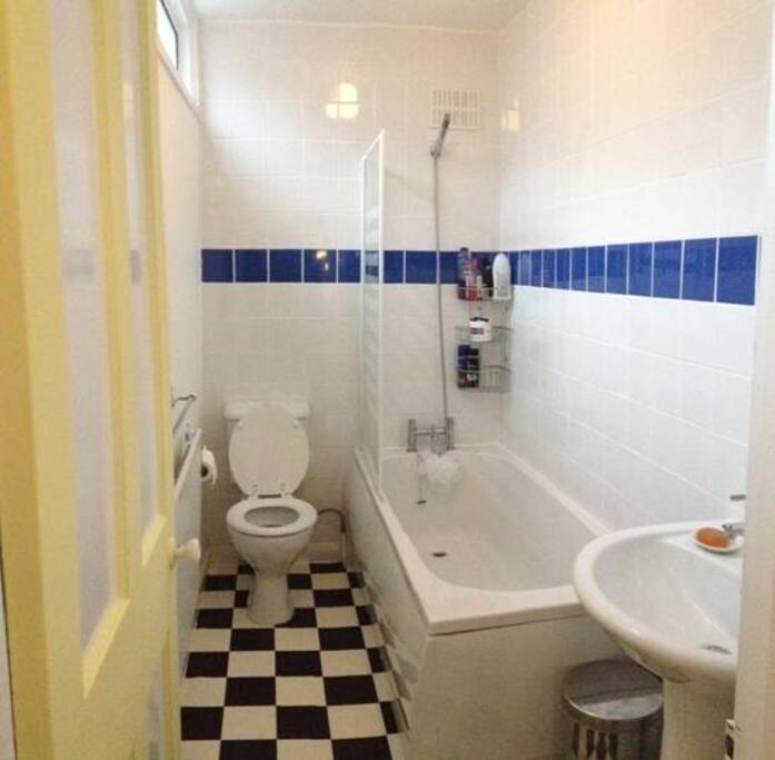 Shared bathroom with both shower and bath.