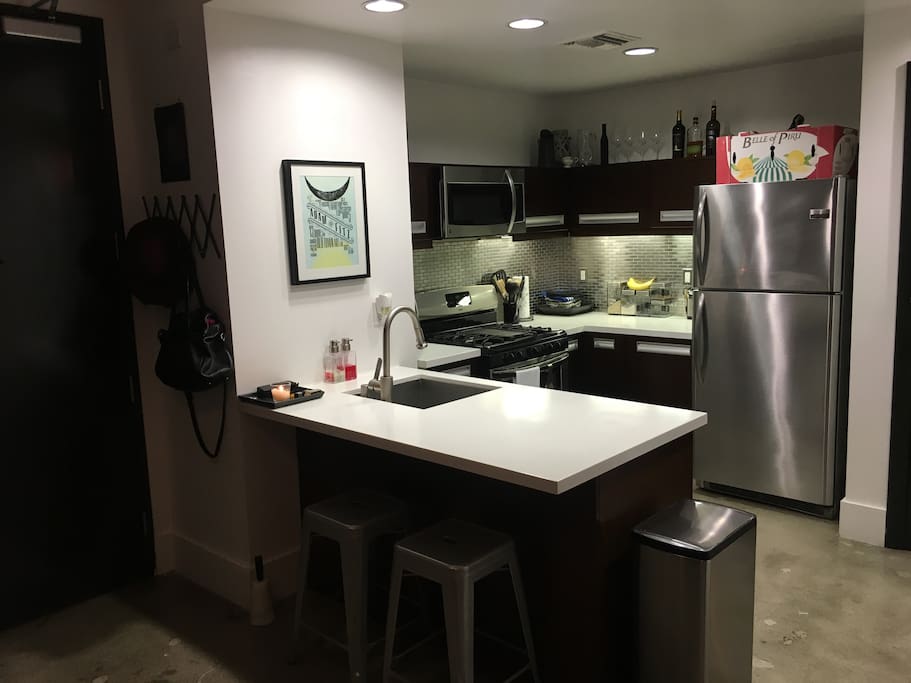 Full kitchen with dishwasher and breakfast bar.