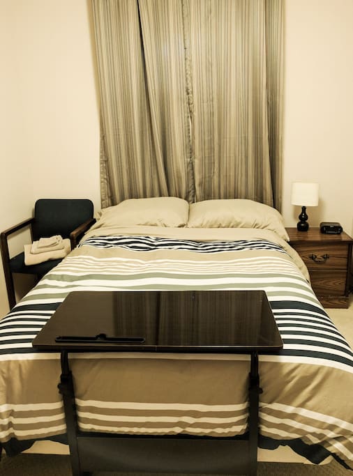 Guest Room - Cozy with double bed, chair & adjustable laptop desk.