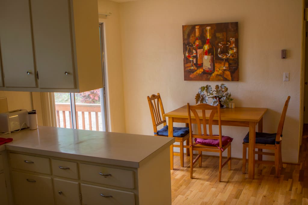 Open space kitchen/dining room area with door to deck.