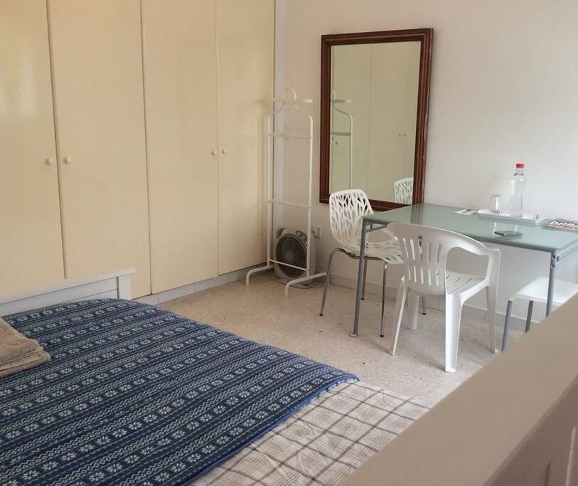Big mirror with glass table and spacious cupboards with hangers.