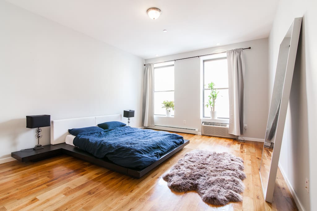 Massive and airy bedroom with a full length mirror