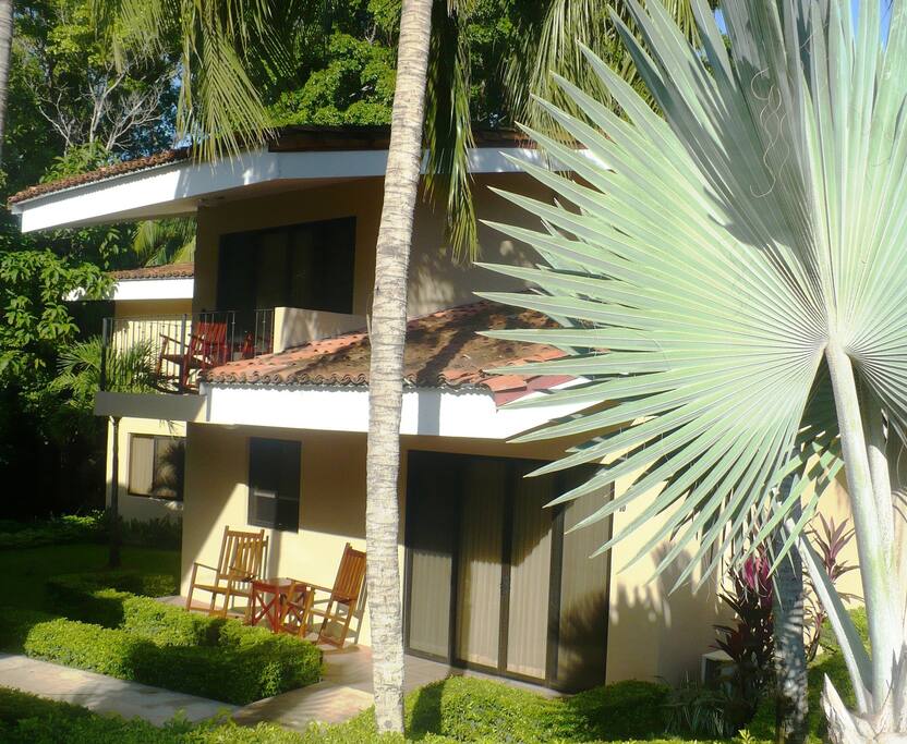 In a lush garden, steps from the community pool