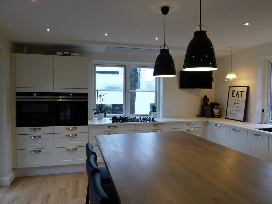 Gas stove and two convection ovens, one of which is a steam oven, plus warming drawer