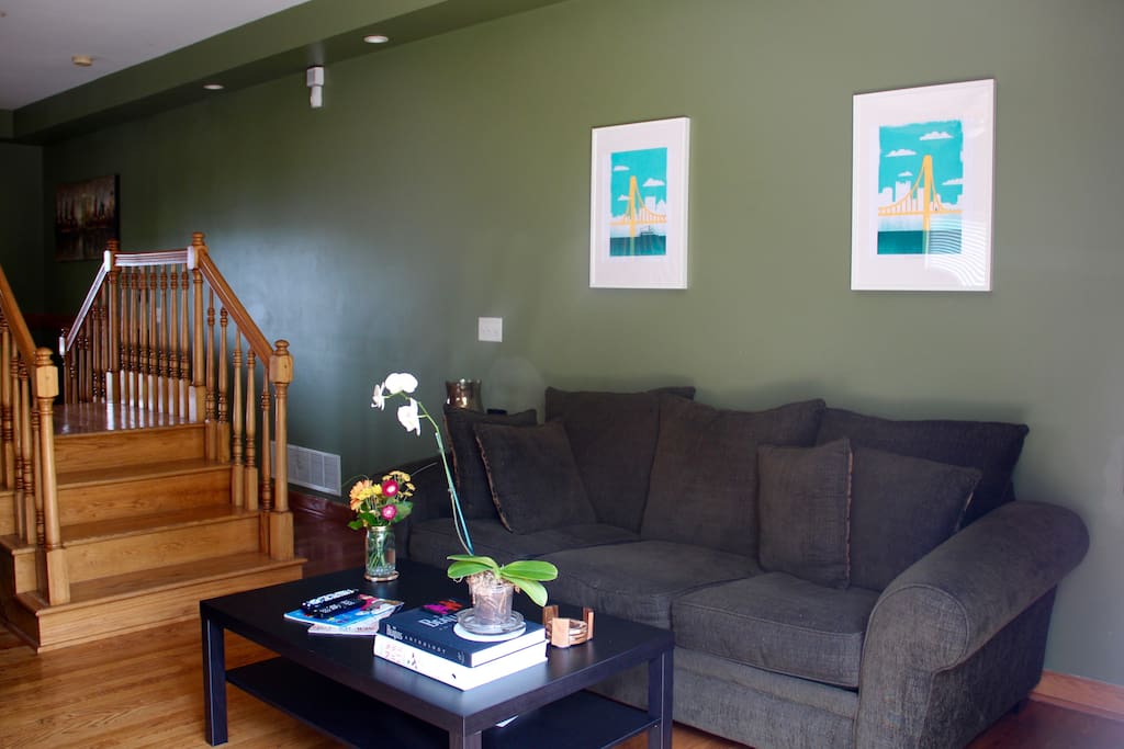 Living room couches are large and comfortable for hanging out or to sleep.