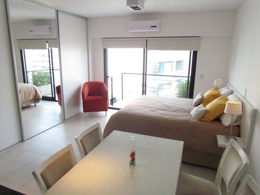 Dining area. Fully equiped bedroom with a comfy red sofa and queen size bed (option to separate and have two twins). AC (hot and cold) Internet Wi-Fi.