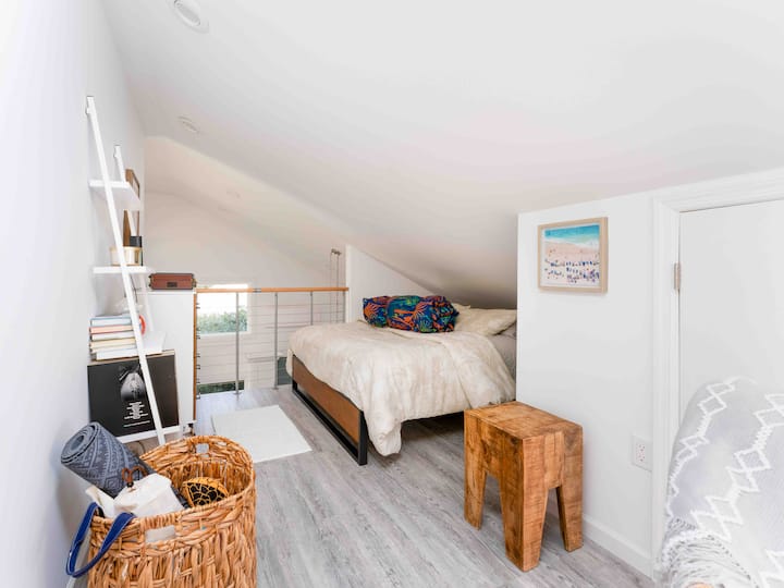 Open air loft bedroom with queen bed. 