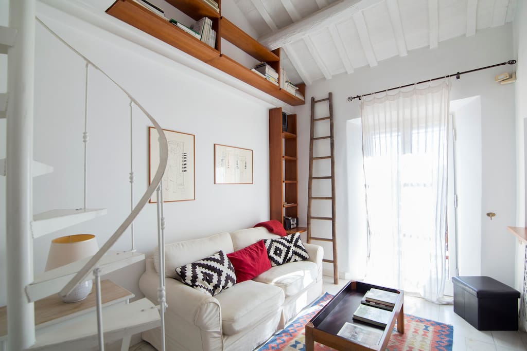 Living room with a glass door, sofa-bed and shelves