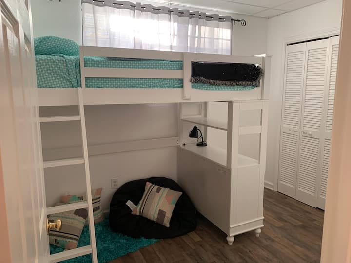 Loft bed with cozy reading nook.