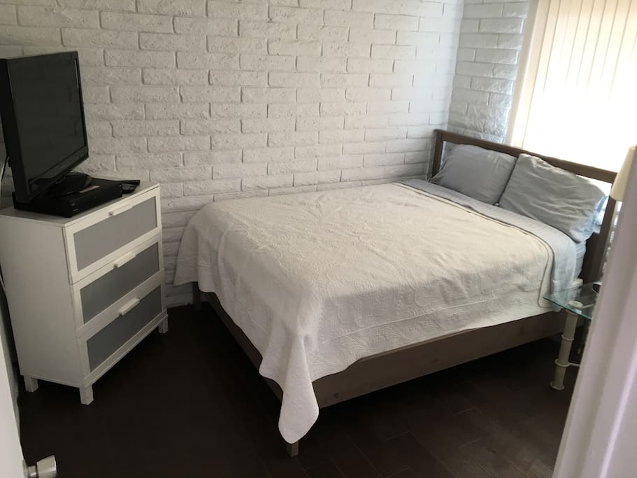 Queen size bed with TV and DVR