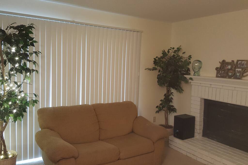 Living room with balcony for designated smoking. Small pull out bed in couch.