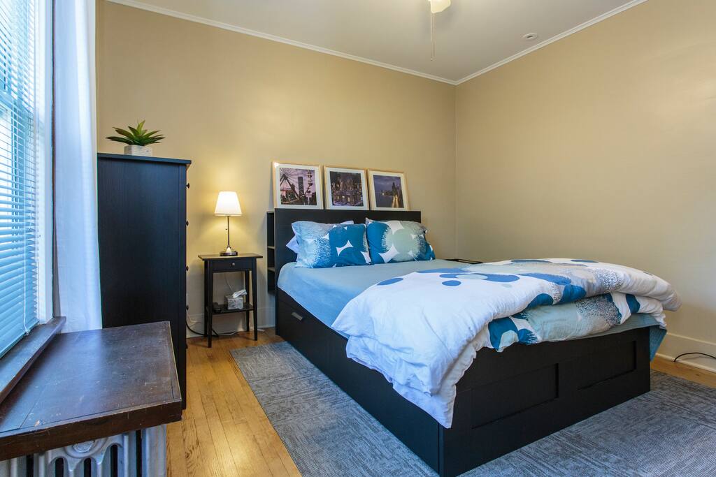 Queen bed with full linen set and nightstand