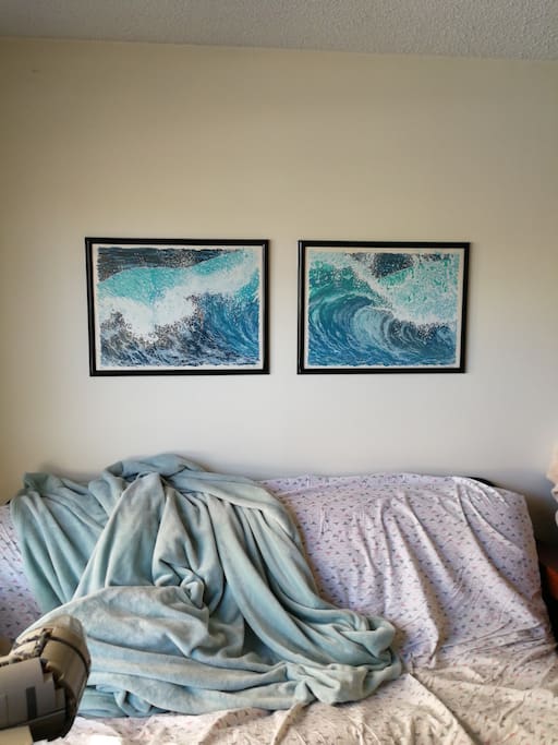 Original art hanging over futon.