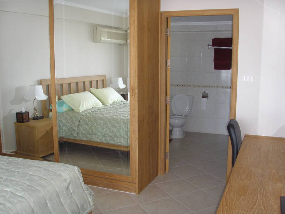 Main air conditioned bedroom with bathroom and built in wardrobes