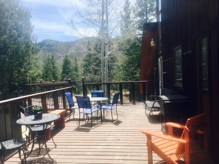 Outside Deck with two tables, 7 chairs and bench