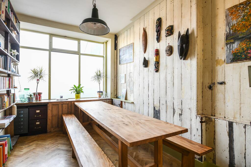 Dining table seats up to 14 people. This is the oldest part of the house (1842) and the wooden board paneling is original. The house was extended by the Victorians and you can see the quirky interior window and door that they left in the next photo.