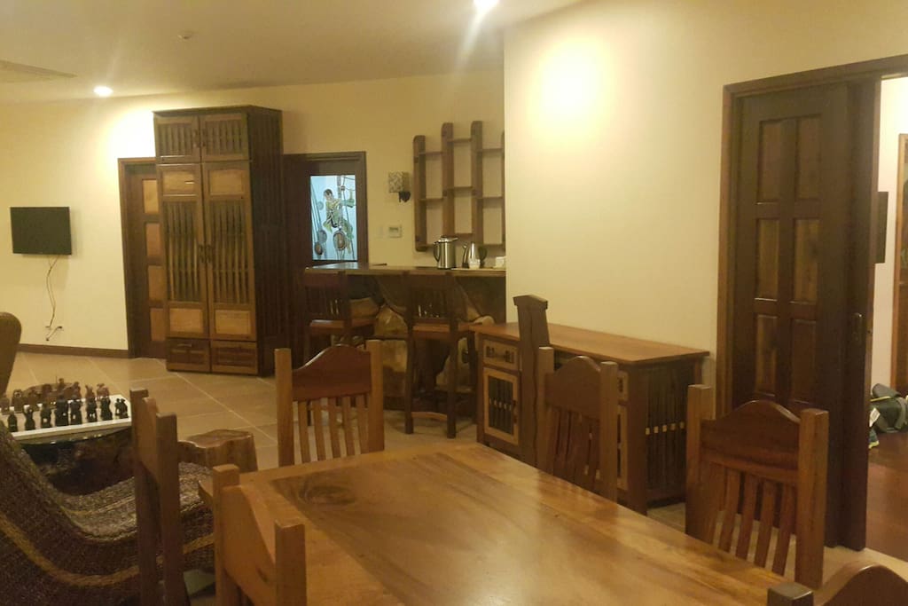 Custom old wood furniture and carvings, dining table, chess area, sala with TV and mini bar
