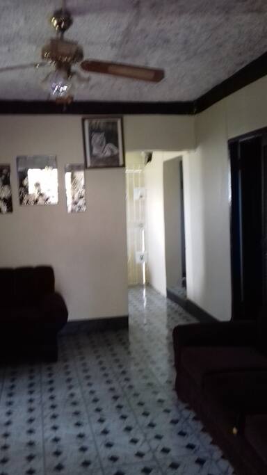 Living room leading into kitchenette (left) and bathroom and workspace (right).