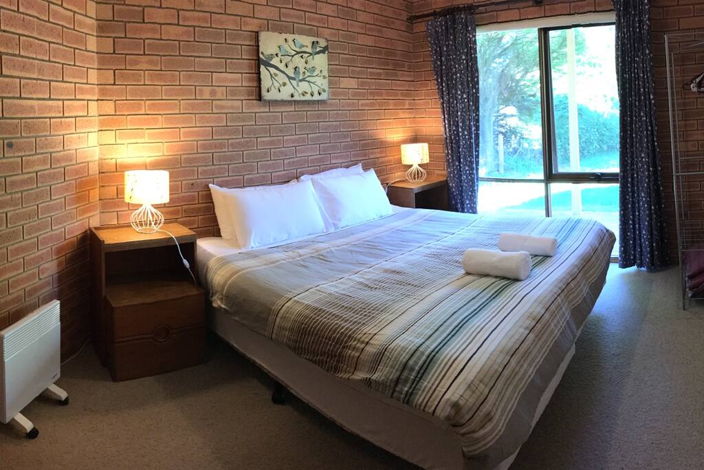 A comfortable king sized bed in the 1st bedroom