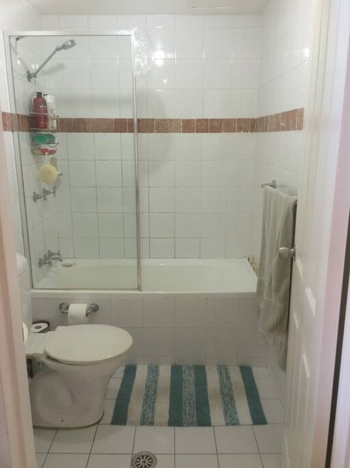 Clean bathroom with shower and bath.