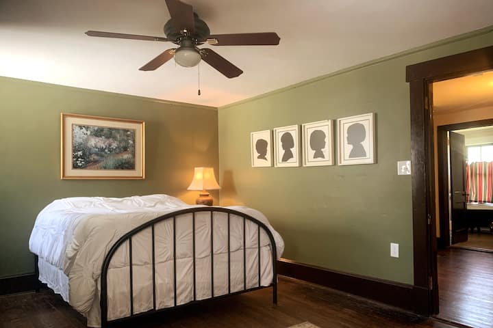 Large Bedroom 3 with a queen bed and sofa.  Hall bathrooms are just outside the door. This room has a window AC unit recently added.