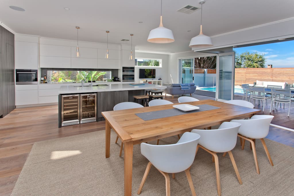 Entertainers kitchen, with built in fridges, pantry, wine and drinks fridges, steam oven, 2 other ovens. 8 seat dining area leading straight onto the deck