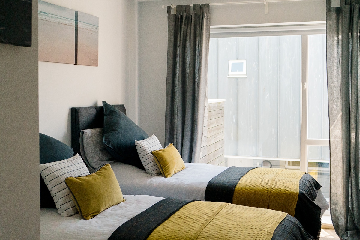 Our Second bedroom with view looking back over Newquay has 'zip and link' single beds which transform into a comfy kingsize! A Travel Cot is also provided for our baby guests.