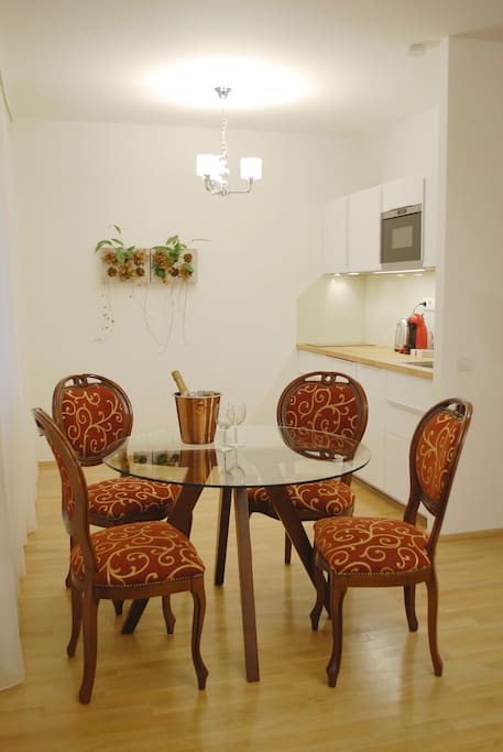Dining table for up to six people and a kitchen