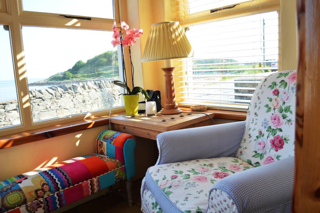 Beautiful and cozy sun lit porch to sit and watch the world go by.