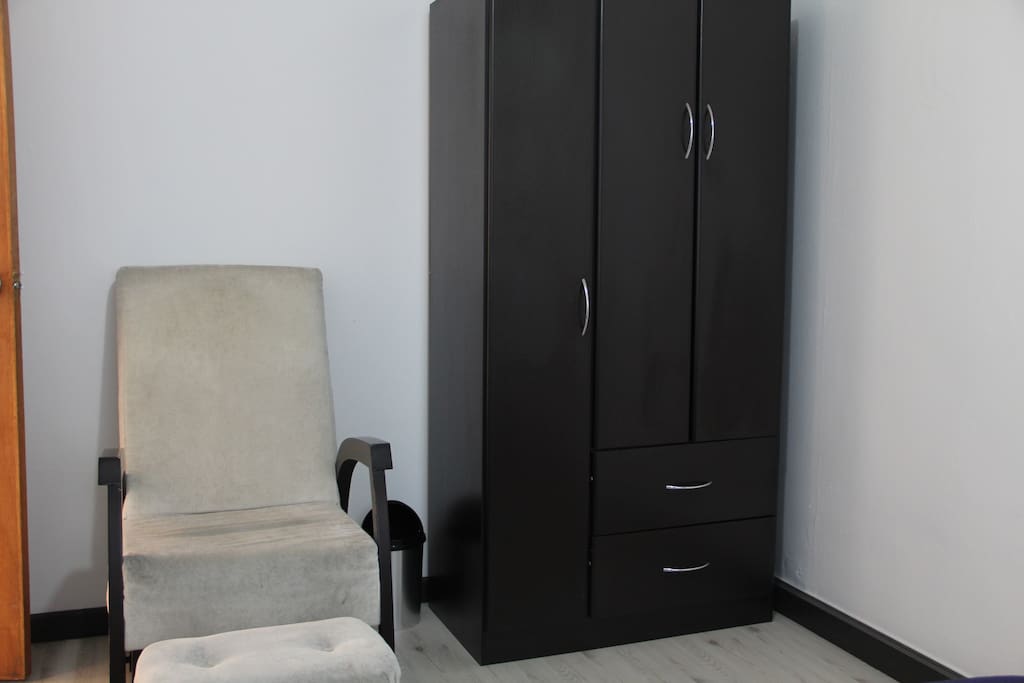 With a dresser and closet