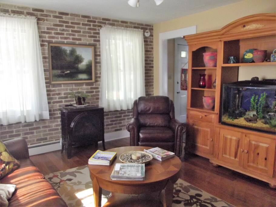 Living room with gas fireplace and aquarium.