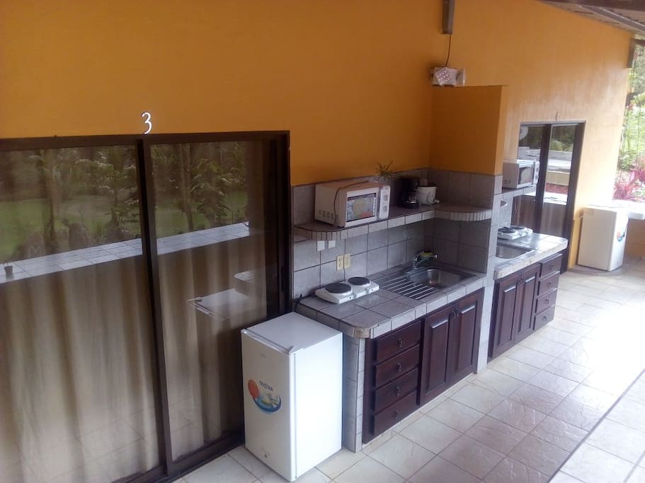 Outdoor kitchenette furnished with a mini fridge, two-electric burners, coffee maker, rice cooker and microwave!