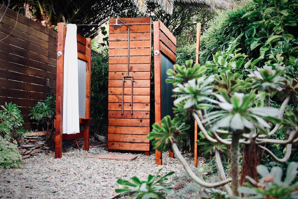 Hot shower in the garden alongside a curtain of bamboo. Handmade, copper pipe shower with a hot and cold valve. Environmentally friendly shampoos and soaps are provided. Hooks for towels and robes are within reach.