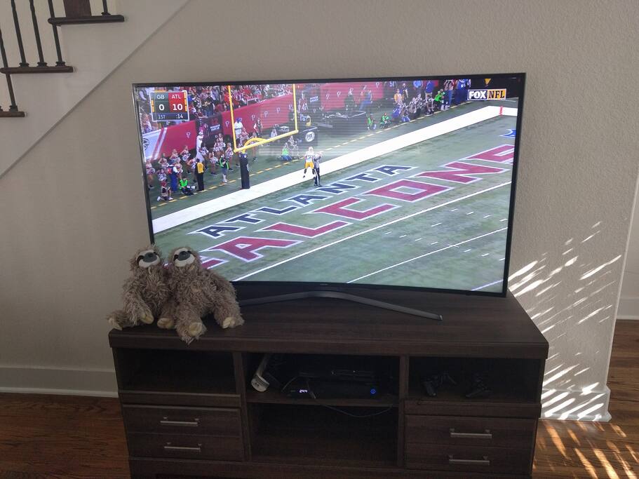 65 inch 4k curved HD TV with cable and Blu-ray player for your enjoyment.