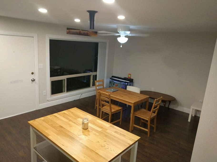 view from kitchen to living/dining. notice the Amazon echo hanging from the ceiling. to the right of the gecko above the window, there is a weather station monitoring temperature, humidity and CO2 levels.