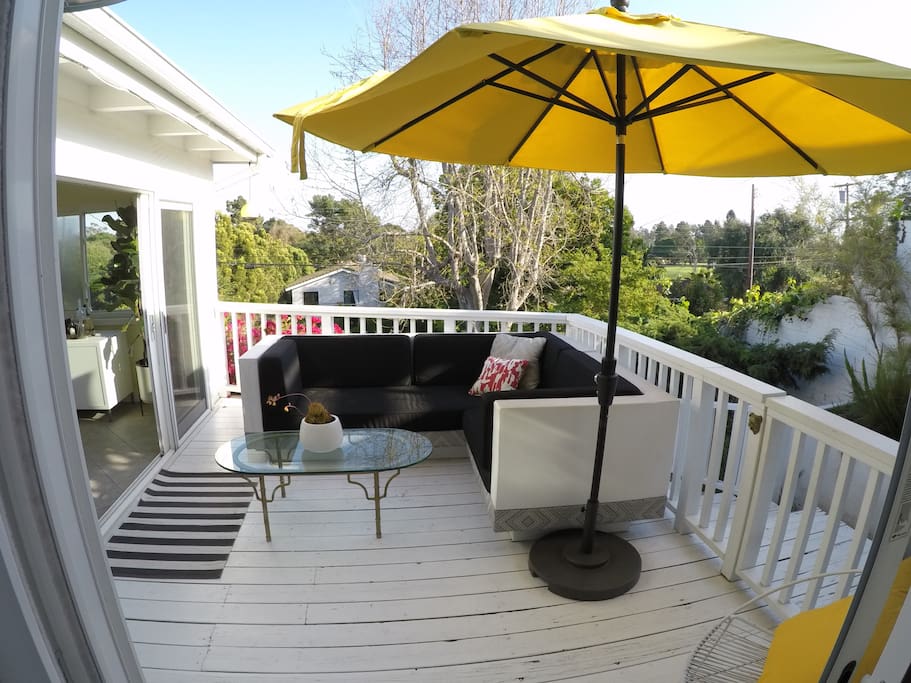 View of deck from master bedroom. Stairs from deck take you down to large private garden