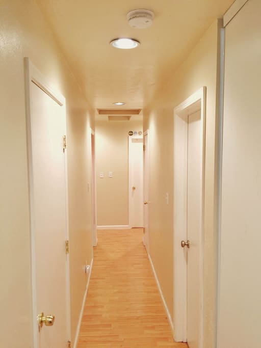 Hallway to all bedrooms. The washer and dryer is also located behind the left wall.