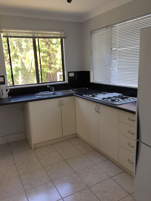 Self contained kitchen with large fridge.