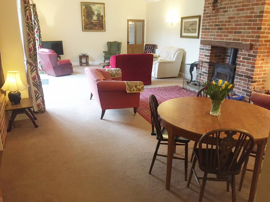 Spacious sitting room with wood burning stove