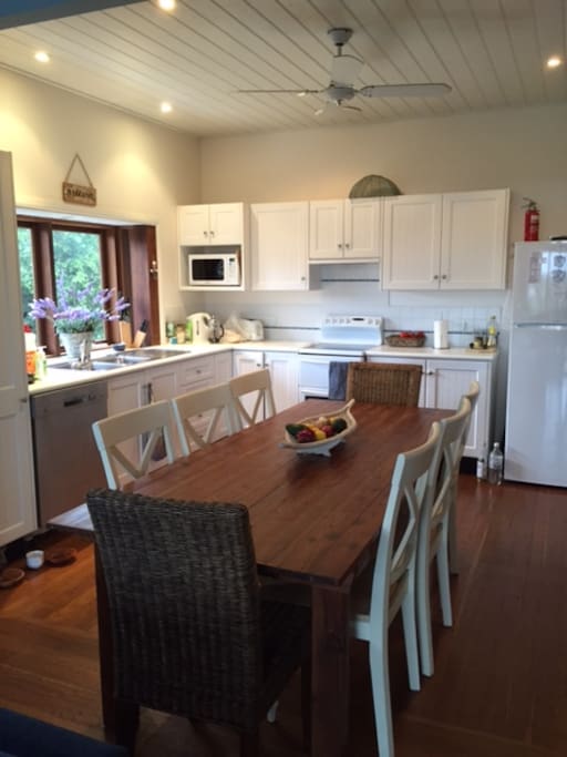 Bright modern kitchen stocked full of equipment and all you need.