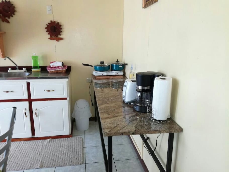 Coffee maker, rice cooker, toaster and kitchen utensils.