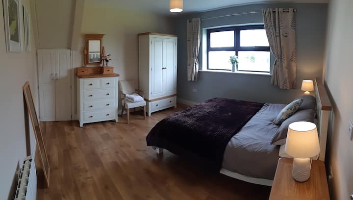 Bright and spacious master bedroom in the Dairy Lodge
