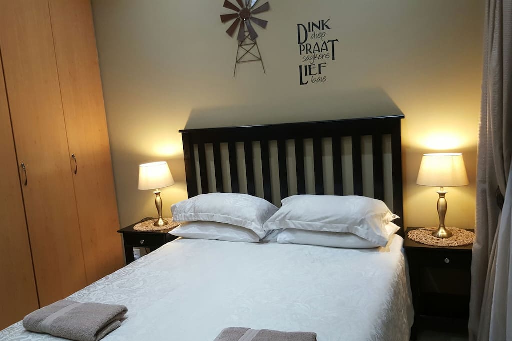 Cupboards, queensize bed, towels, hairdryer and dressertable