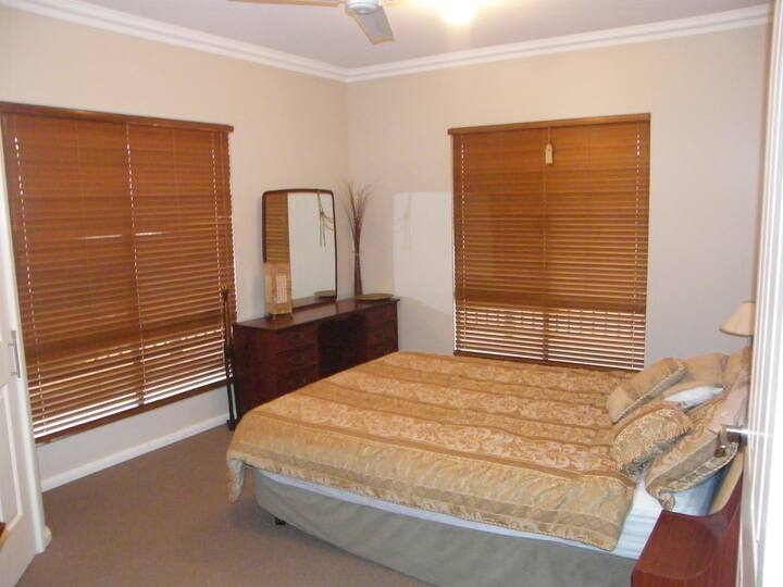 Queen bedroom downstairs with robe and  next to the main bathroom with semi ensuite door