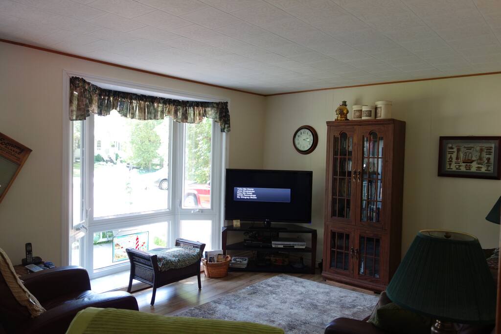 The spacious living room has new laminate flooring stretching into the dining room.
